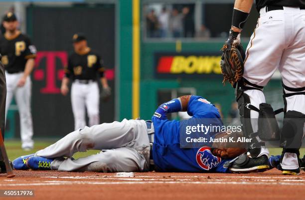 Emilio Bonifacio of the Chicago Cubs grimmaces with an injury in the first inning during the game against the Pittsburgh Pirates at PNC Park on June...