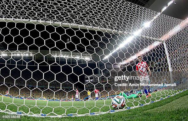 Stipe Pletikosa of Croatia dives attempting to save a penalty kick taken by Neymar of Brazil in the second half during the 2014 FIFA World Cup Brazil...