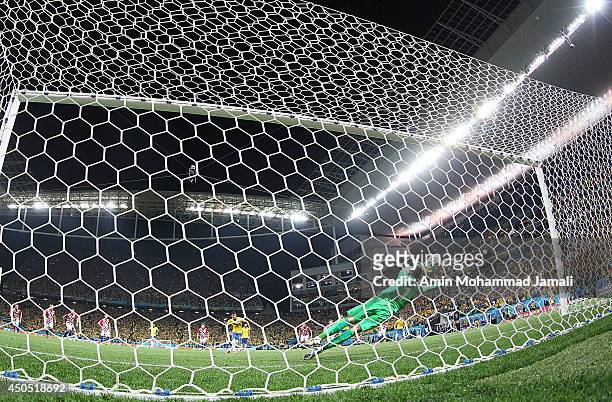 Stipe Pletikosa of Croatia dives attempting to save a penalty kick taken by Neymar of Brazil in the second half during the 2014 FIFA World Cup Brazil...