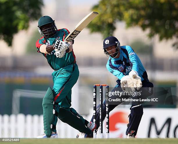 Steve Tikolo of Kenya hits the ball towards the boundary, as David Murphy of Scotland looks on during the ICC World Twenty20 Qualifier match between...