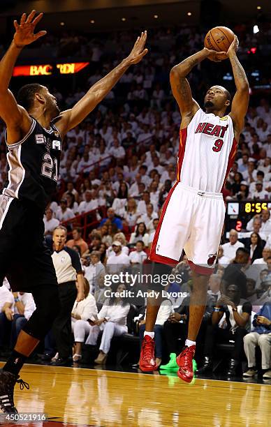 Rashard Lewis of the Miami Heat takes a shot over Tim Duncan of the San Antonio Spurs during Game Four of the 2014 NBA Finals at American Airlines...