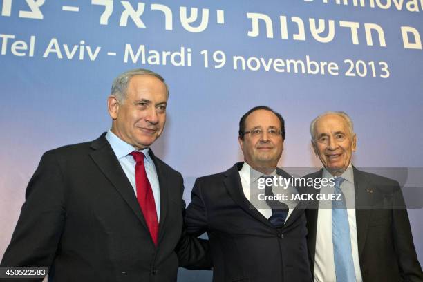 French President Francois Hollande poses for a picture with his Israeli counterpart Shimon Peres and the Jewish state's Prime Minister Benjamin...