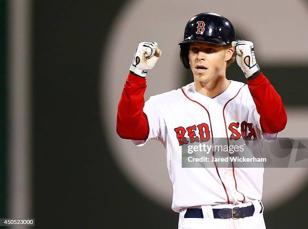 Brock Holt of the Boston Red Sox reacts at second base following his two-run double in the sixth inning against the Cleveland Indians during the game...