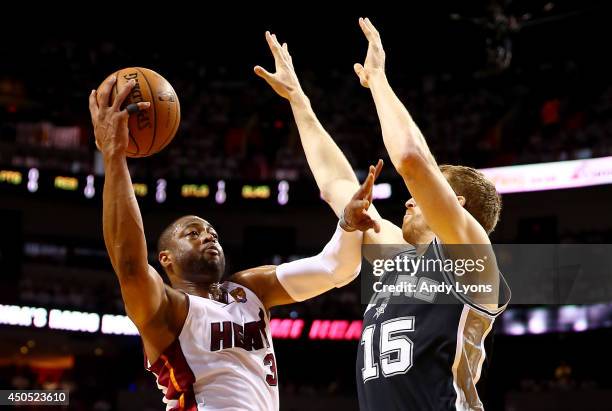 Dwyane Wade of the Miami Heat goes up to the basket against Matt Bonner of the San Antonio Spurs during Game Four of the 2014 NBA Finals at American...