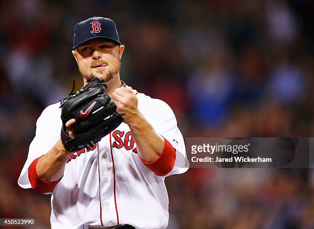Jon Lester of the Boston Red Sox reacts following a double play to end the seventh inning against the Cleveland Indians during the game at Fenway...