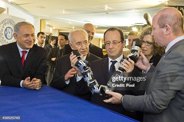 French President Francois Hollande , Israeli Prime Minister Benjamin Netanyahu and President Shimon Peres look at a snake camera at French-Israeli...