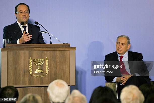 Israeli Prime Minister Benjamin Netanyahu listens to French President Francois Hollande's speech during their visit to a French-Israeli technology...