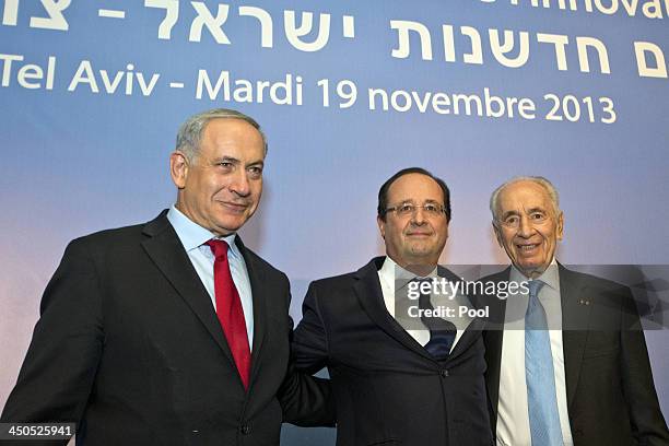 French President Francois Hollande poses for a picture with his Israeli counterpart Shimon Peres and the Israel's Prime Minister Benjamin Netanyahu...