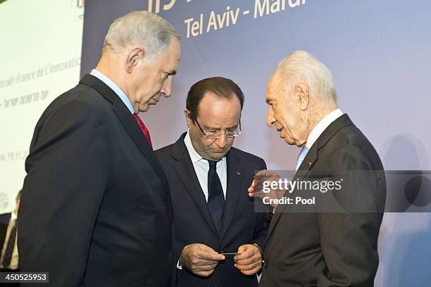 French President Francois Hollande stands with his Israeli counterpart Shimon Peres and the Israel's Prime Minister Benjamin Netanyahu during their...