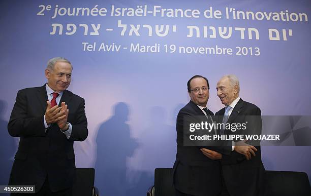 French President Francois Hollande poses with his Israeli counterpart Shimon Peres and Prime Minister Benjamin Netanyahu during their visit to the...