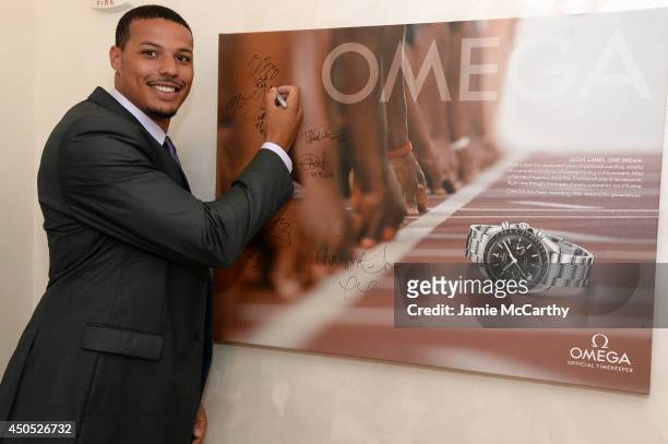 Olympic athlete Ryan Bailey signs his autograph at the adidas Grand Prix celebration hosted by OMEGA at the OMEGA Fifth Avenue Boutique on June 12,...