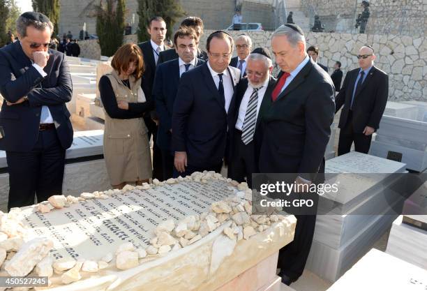 In this handout provided by the GPO, Israeli Prime Minister Benjamin Netanyahu and French President Francois Hollande lay tributes to the victims of...