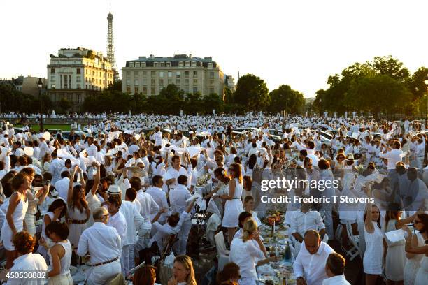 People attend the 26th Diner en Blanc outdoor picnic event on the Alexander III Bridge on June 12, 2014 in Paris, France. The event, which organizers...