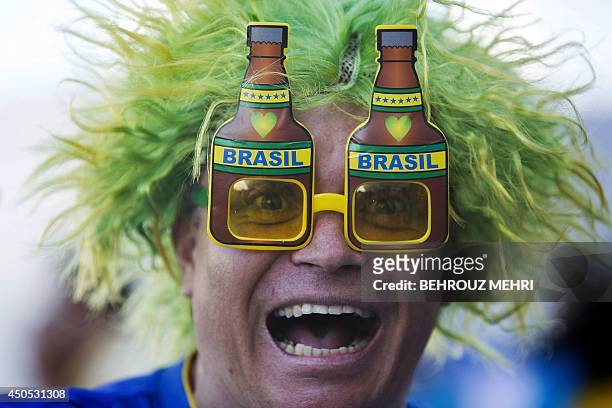 Brazilian fan poses outside the Corinthians Arena in Sao Paulo prior to the start of the Group A opening football match between Brazil and Croatia...