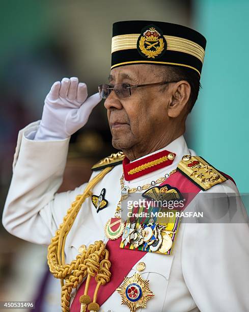 Malaysia's King Abdul Halim Mu'adzam Shah salutes honour guards during his official birthday celebration in Kuala Lumpur on June 13, 2014. King Abdul...