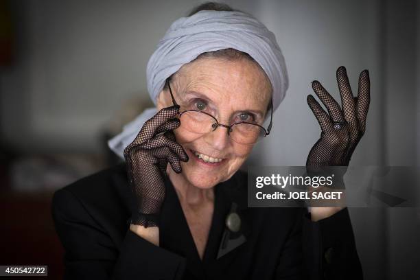 French writer Catherine Robbe-Grillet poses at her home in Neuilly-sur-Seine, near Paris, on June 12, 2014. AFP PHOTO / JOEL SAGET