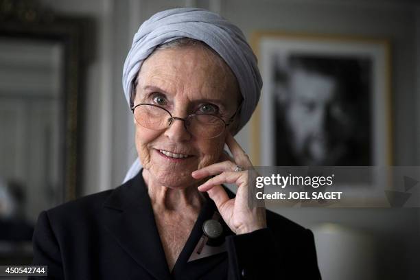 French writer Catherine Robbe-Grillet poses at her home in Neuilly-sur-Seine, near Paris, on June 12, 2014. AFP PHOTO / JOEL SAGET