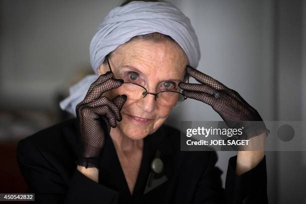 French writer Catherine Robbe-Grillet poses at her home in Neuilly-sur-Seine, near Paris, on June 12, 2014. AFP PHOTO / JOEL SAGET