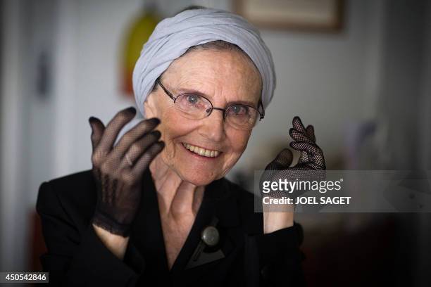 French writer Catherine Robbe-Grillet poses at her home in Neuilly-sur-Seine, near Paris, on June 12, 2014. AFP PHOTO / JOEL SAGET