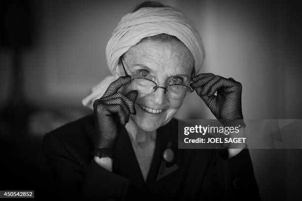 French writer Catherine Robbe-Grillet poses at her home in Neuilly-sur-Seine, near Paris, on June 12, 2014. AFP PHOTO / JOEL SAGET