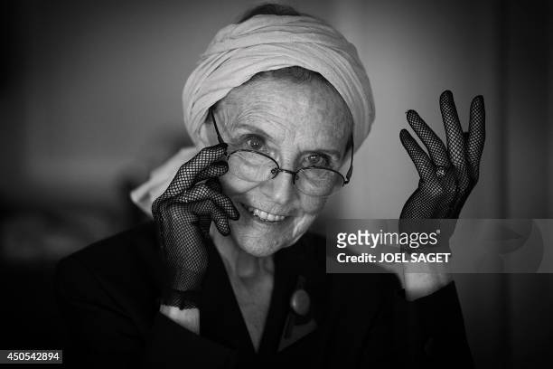 French writer Catherine Robbe-Grillet poses at her home in Neuilly-sur-Seine, near Paris, on June 12, 2014. AFP PHOTO / JOEL SAGET