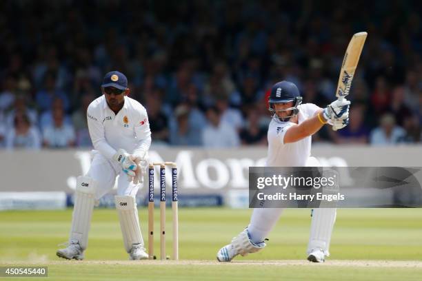 Matt Prior of England hits out watched by Sri Lankan wicketkeeper Prasanna Jayawardene during day two of the 1st Investec Test match between England...