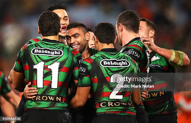 Nathan Merritt of the Rabbitohs celebrates with team mates after scoring during the round 14 NRL match between the South Sydney Rabbitohs and the...