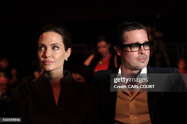 Actress and special UN envoy Angelina Jolie and her husband US actor Brad Pitt attend the fourth day of the Global Summit to End Sexual Violence in...