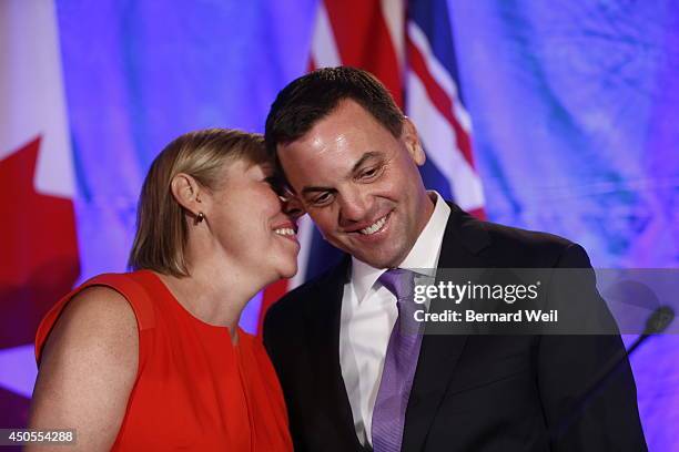 Ontario Progressive Conservative leader Tim Hudak, right, announces next to his wife Deb Hutton that he will be stepping down as party leader after...