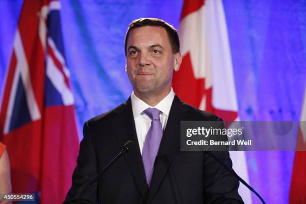 Ontario Progressive Conservative leader Tim Hudak, right, announces next to his wife Deb Hutton that he will be stepping down as party leader after...