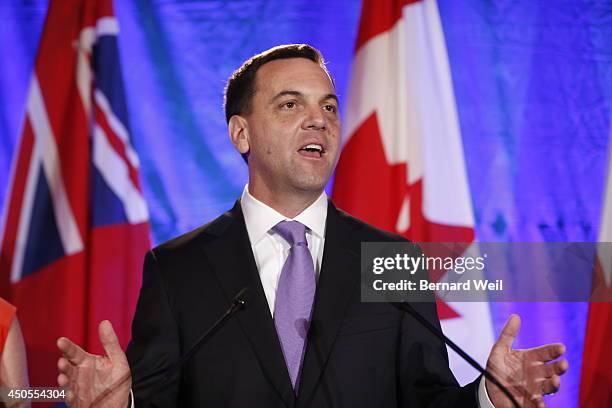 Ontario Progressive Conservative leader Tim Hudak, right, announces next to his wife Deb Hutton that he will be stepping down as party leader after...