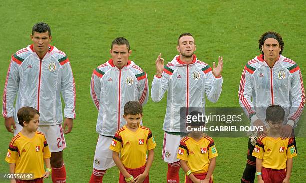 Mexico's defender Francisco Rodriguez, defender Paul Aguilar, defender Miguel Layun and goalkeeper Guillermo Ochoa listen to their national anthem...