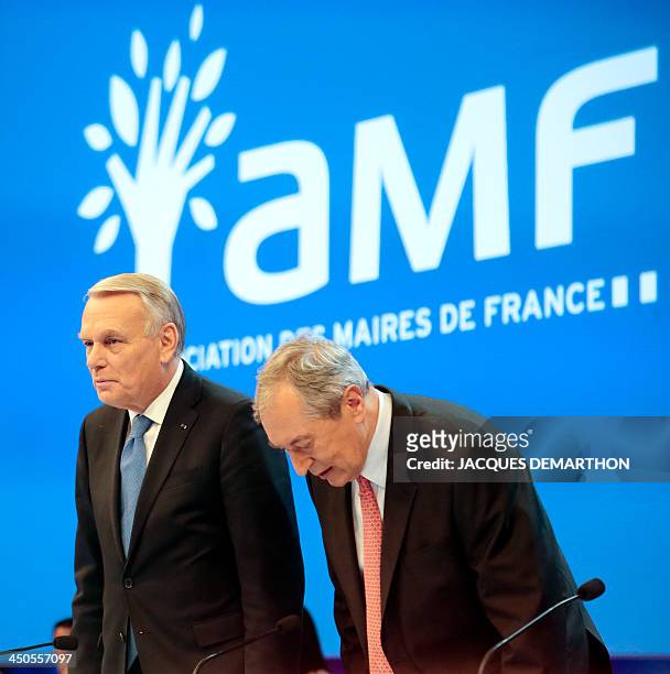 French Prime Minister Jean-Marc Ayrault arrives with President of the French mayors' association , Jacques Pelissard, to attend the 96th French...