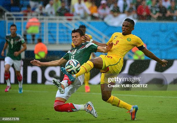 Mexico's defender Hector Moreno challenges Cameroon's forward Samuel Eto'o during the Group A football match between Mexico and Cameroon at the Dunas...