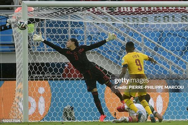 Cameroon's forward and captain Samuel Eto'o shoots towards Mexico's goalkeeper Guillermo Ochoa during a Group A football match between Mexico and...