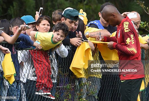 Brazilian national football team goalkeeper Jefferson signs autographs to fans at the end of a training session of the Brazilian national football...