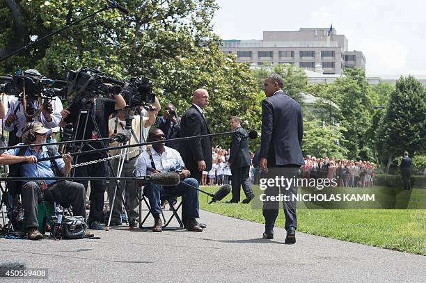 President Barack Obama walks past members of the press after making a statement on the situation in Iraq on the South Lawn of the White House in...