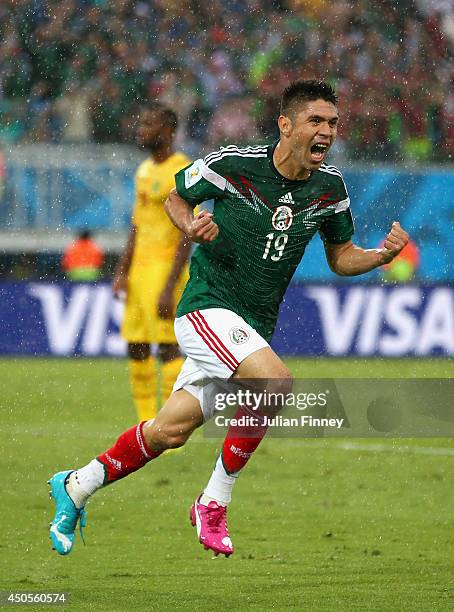 Oribe Peralta of Mexico celebrates his goal in the second half during the 2014 FIFA World Cup Brazil Group A match between Mexico and Cameroon at...