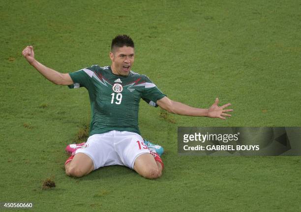 Mexico's forward Oribe Peralta celebrates after scoring a goal during the Group A football match between Mexico and Cameroon at the Dunas Arena in...