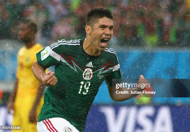 Oribe Peralta of Mexico celebrates his goal in the second half during the 2014 FIFA World Cup Brazil Group A match between Mexico and Cameroon at...