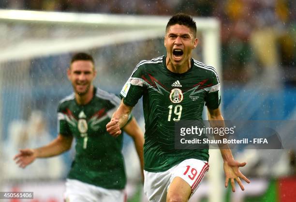 Oribe Peralta of Mexico celebrates after scoring a goal during the 2014 FIFA World Cup Brazil Group A match between Mexico and Cameroon at Estadio...