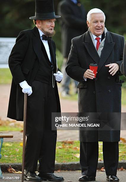 Former US President Abraham Lincoln portrayer James Getty chats with Pennsylvania Governor Tom Corbett before the start of the commemoration ceremony...