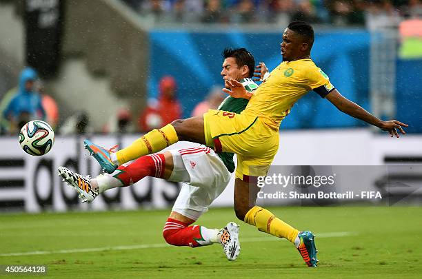 Samuel Eto'o of Cameroon is challenged by Hector Moreno of Mexico during the 2014 FIFA World Cup Brazil Group A match between Mexico and Cameroon at...