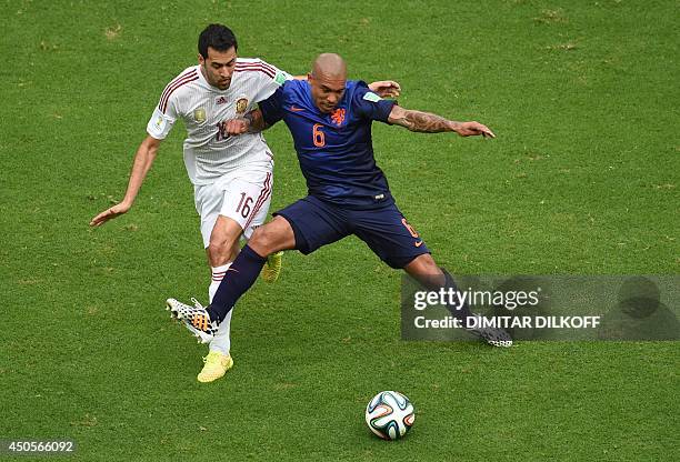 Spain's midfielder Sergio Busquets vies with Netherlands' midfielder Nigel de Jong during a Group B football match between Spain and the Netherlands...