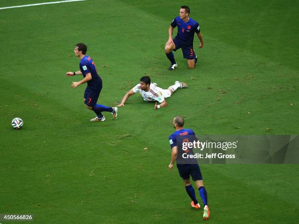 Diego Costa of Spain lies on the field after being fould by Gerard Pique of Spain and awarded a penalty kick in the first half during the 2014 FIFA...