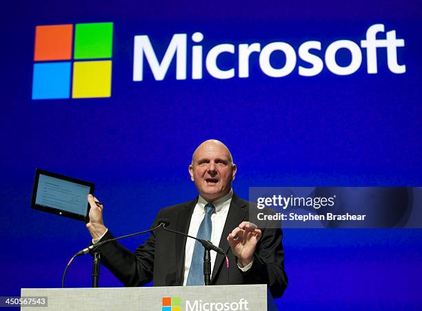 Microsoft CEO Steve Ballmer addresses shareholders while holding up a tablet during the Microsoft Shareholders Annual Meeting November 19, 2013 in...