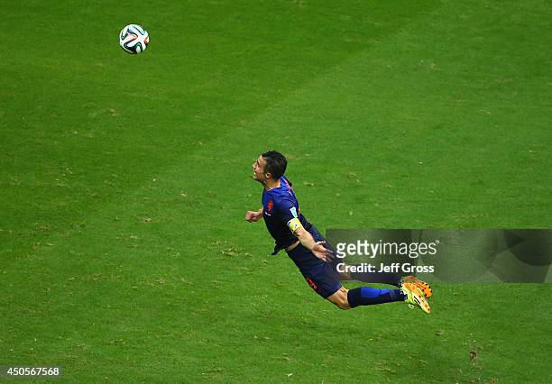 Robin van Persie of the Netherlands scores the team's first goal with a diving header in the first half during the 2014 FIFA World Cup Brazil Group B...