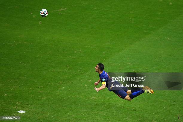 Robin van Persie of the Netherlands scores the team's first goal with a diving header in the first half during the 2014 FIFA World Cup Brazil Group B...