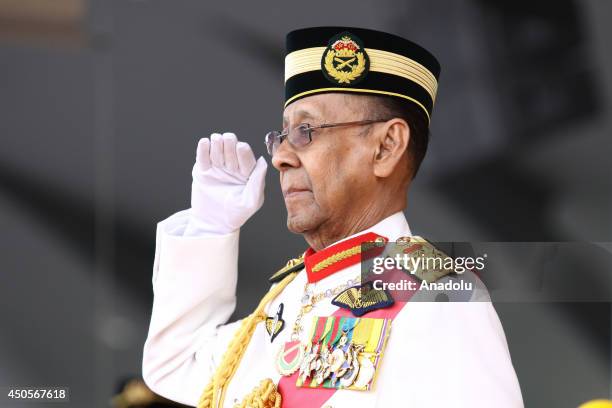 Malaysian King Abdul Halim Mu'adzam Shah salutes Malaysia's armed forces during the Trooping the Colour ceremony in conjunction with the Yang...