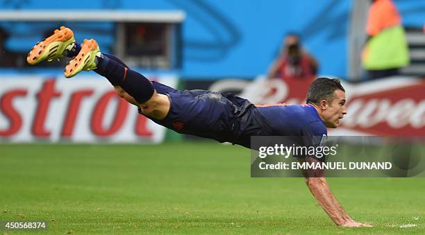 Netherlands' forward Robin van Persie heads the ball and scores during a Group B football match between Spain and the Netherlands at the Fonte Nova...